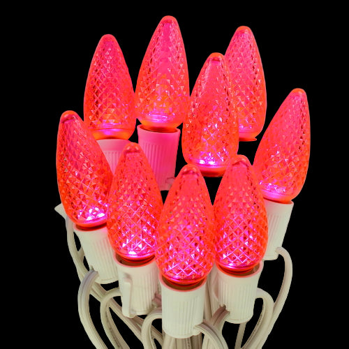 Cluster of red LED Christmas light bulbs on a black background